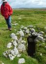 Randall looks into a tumulus at Moor Divock